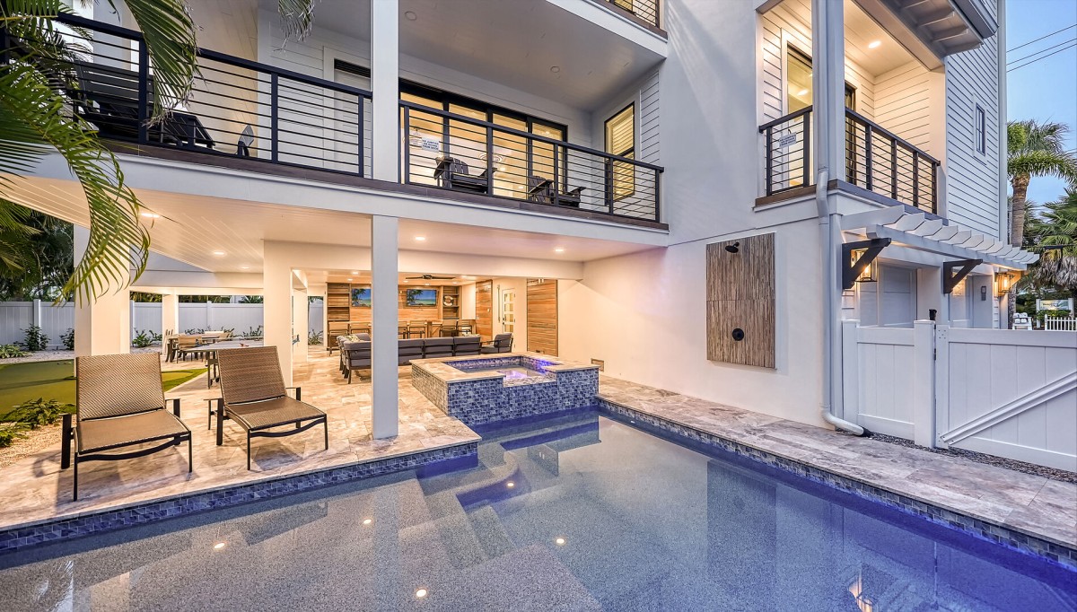 Slide into the crystal-clear spa as the spa waterfall hums beside you—this lanai is your private luxury haven.