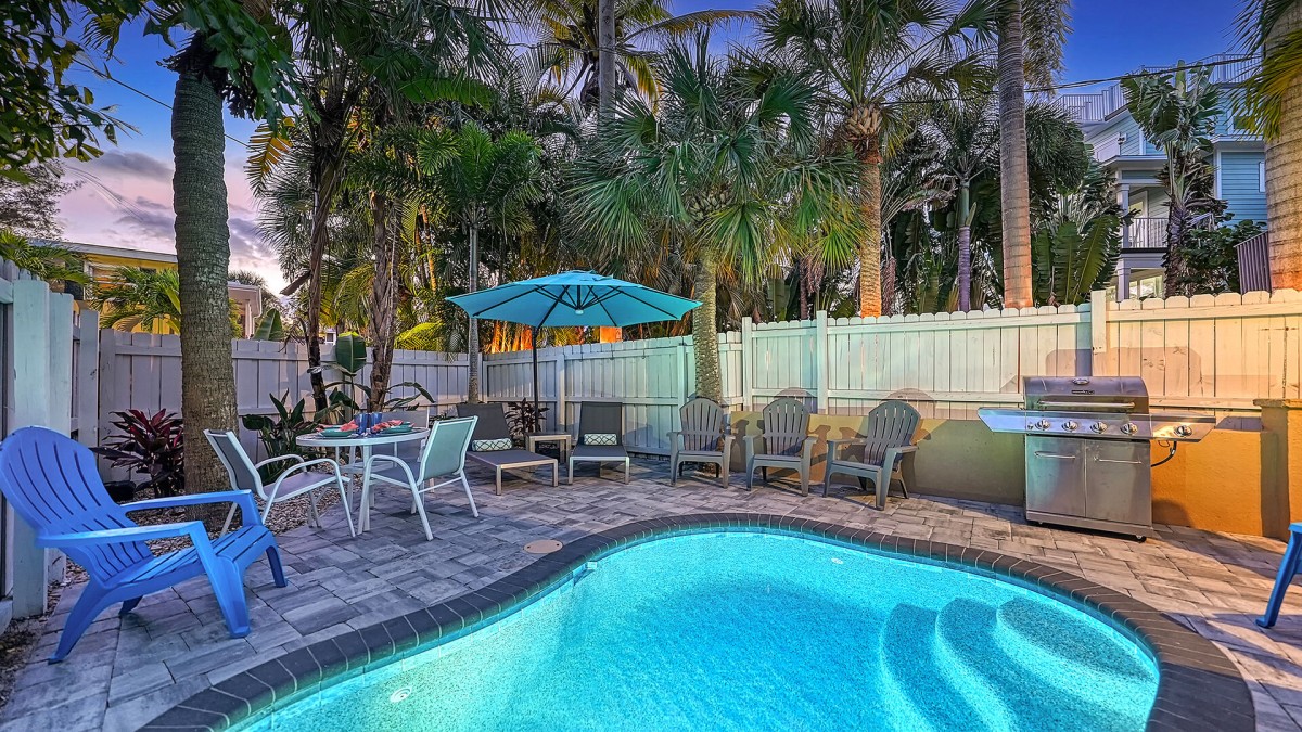 Slip into the crystal-clear water of your private heated pool—surrounded by lush palms and total privacy.