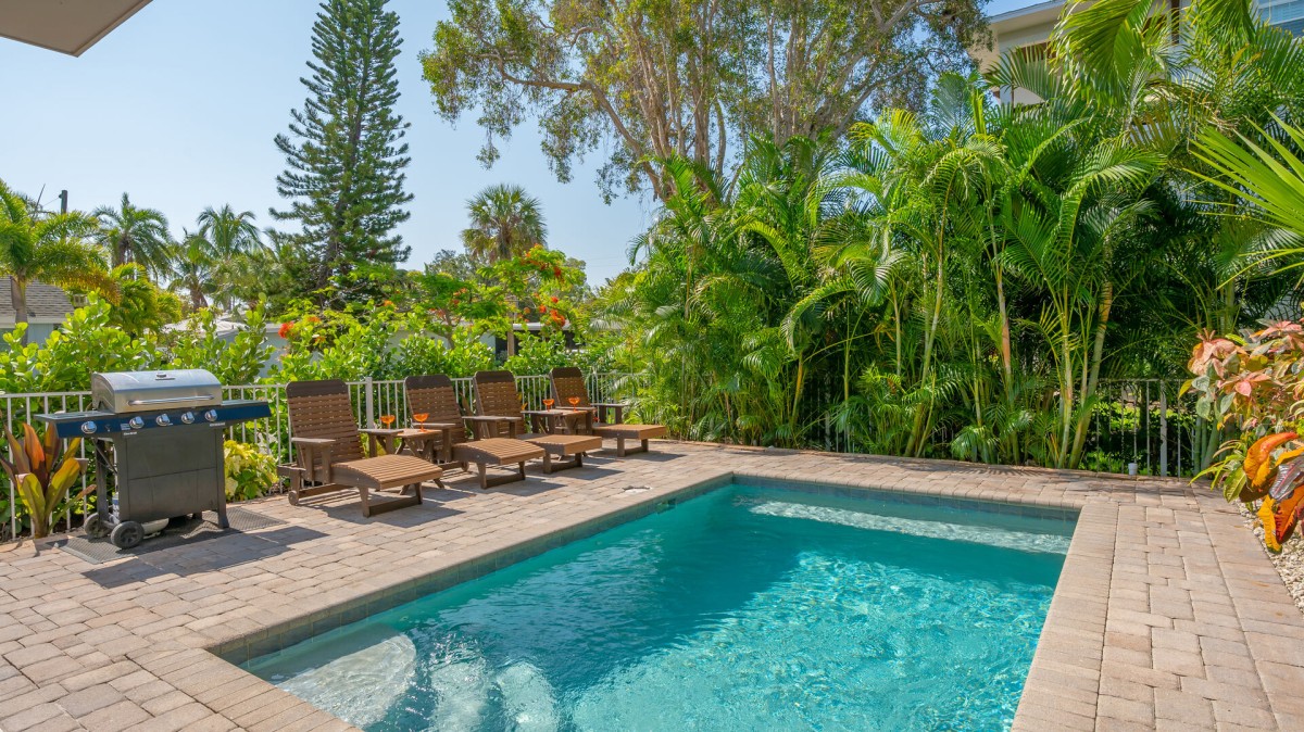 Slip into sun-drenched serenity—your private heated pool is calling from beneath the palms.