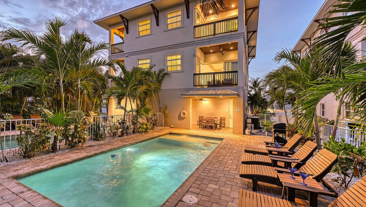 Evenings glow with possibility as your private pool and lantern-lit lanai invite one last swim under swaying palms and a sky fading to indigo.