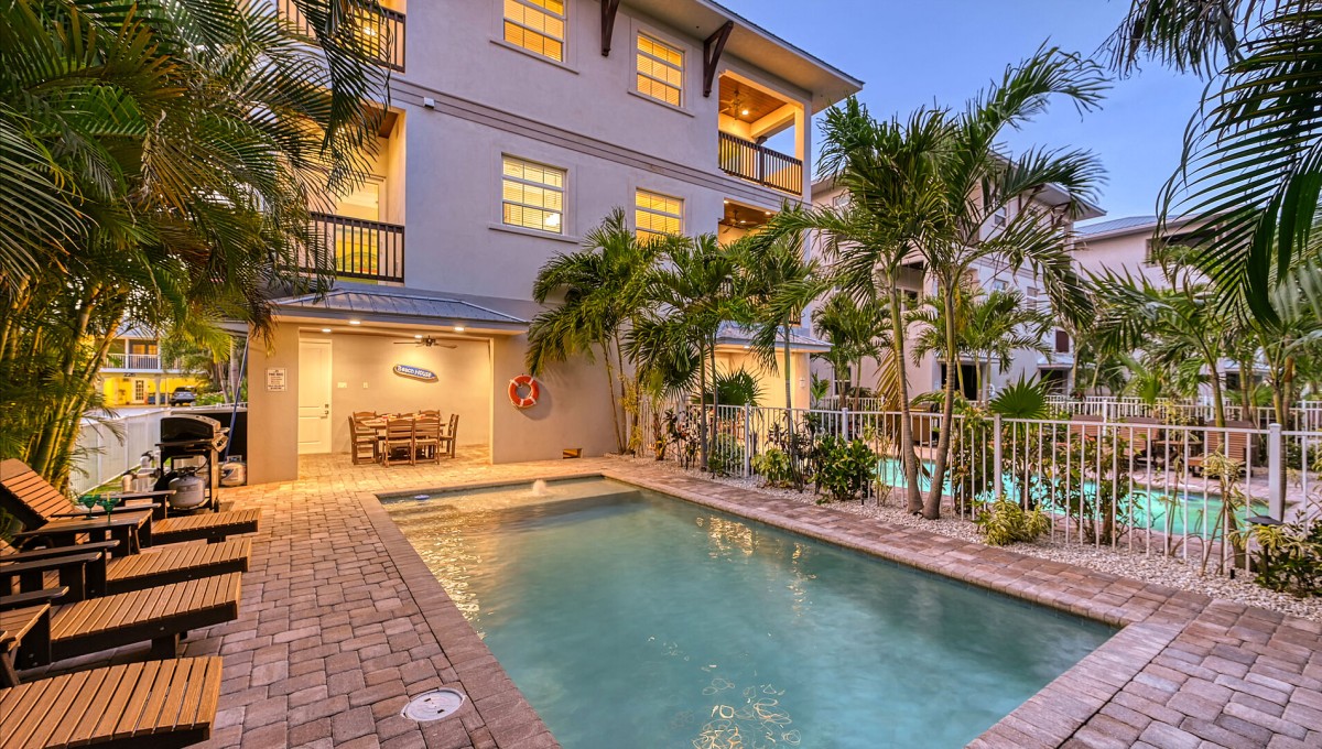 Your private evening sanctuary awaits—twilight hues kiss the pool's surface, while the lanai glows softly, inviting you to unwind under the stars.