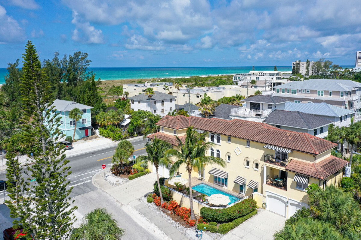 Aerial view of the home showcasing ideal proximity to the beach.