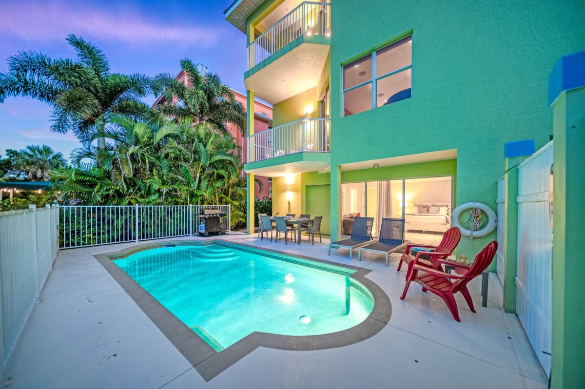 Twilight glistens on the sparkling pool as loungers invite you to relax while the palms sway.