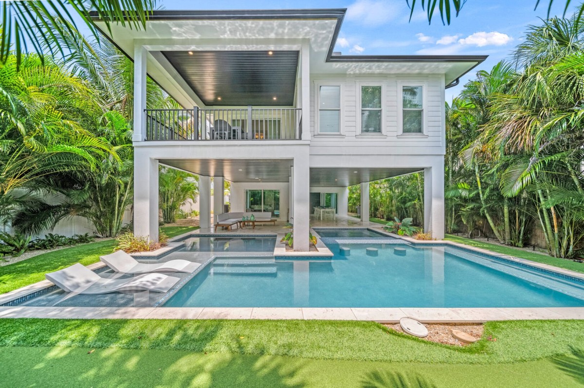Your private resort—sparkling pool, aqua loungers, and balconies rising above it all.