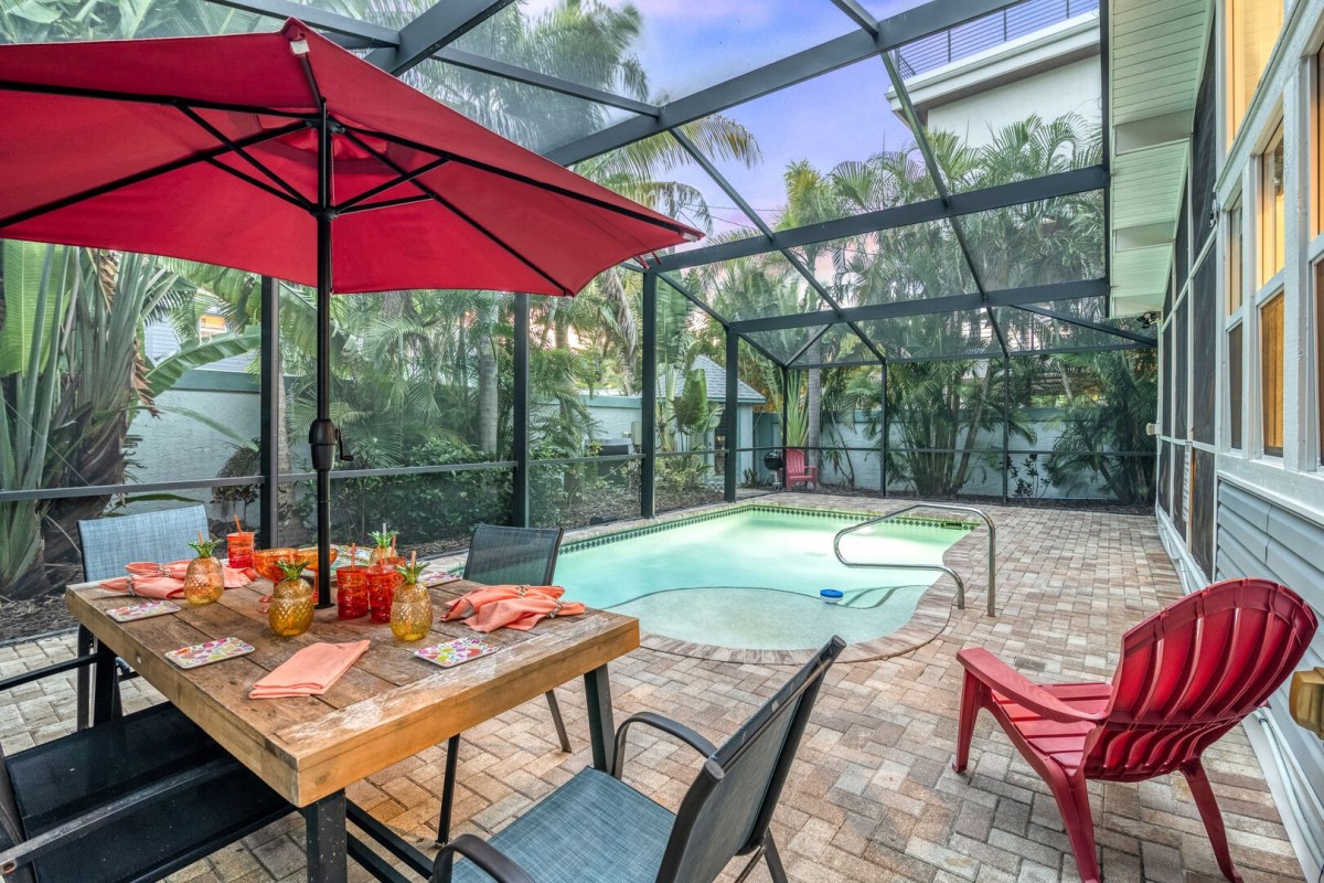 As the sky softens into dusk, this private poolside lanai becomes a glowing, tranquil escape—dinner here feels like a scene from a movie.