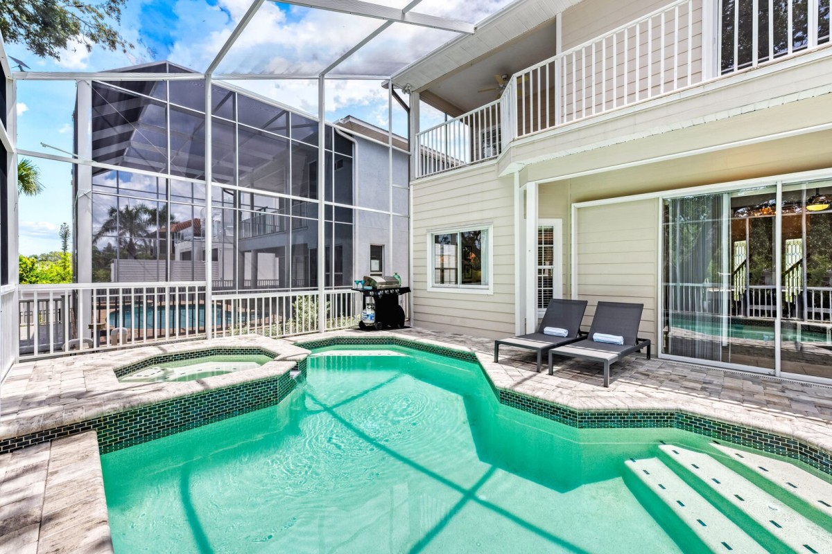 Slip into sun-drenched serenity—your private canal-front screened-in pool awaits.