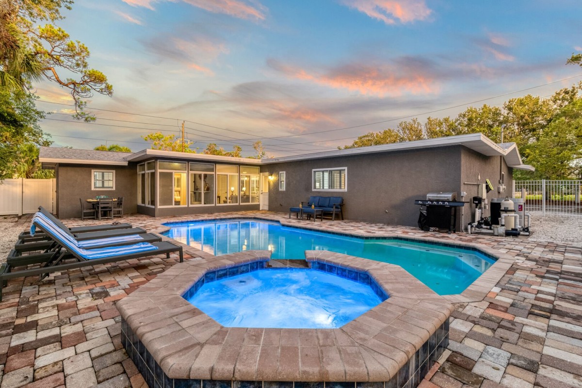 Welcome to your tropical oasis—soak up the sun beside the sparkling heated pool.
