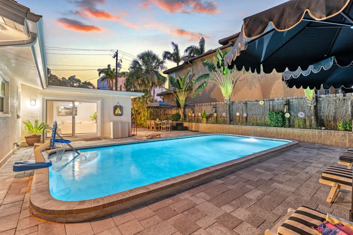 As the sun sets, the pool comes alive with soft lighting, offering a magical backdrop for an evening swim or cocktail.