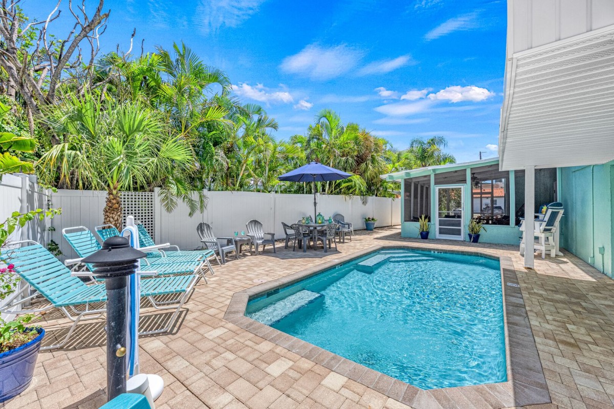 From the comfort of the chaise lounges, take in the inviting heated pool surrounded by swaying palms.