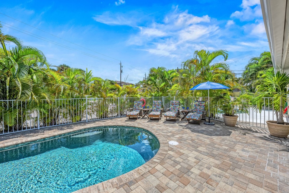 Step into your private tropical sanctuary—warm water glistens under the sun, surrounded by lush greenery and the gentle hum of island life.