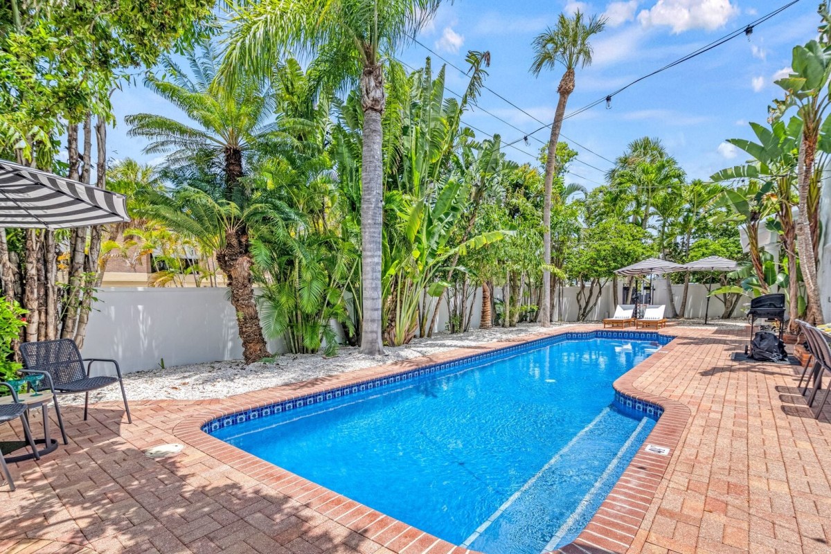 Sink into pure serenity as palm shadows dance across the patio and the crystal-clear water.