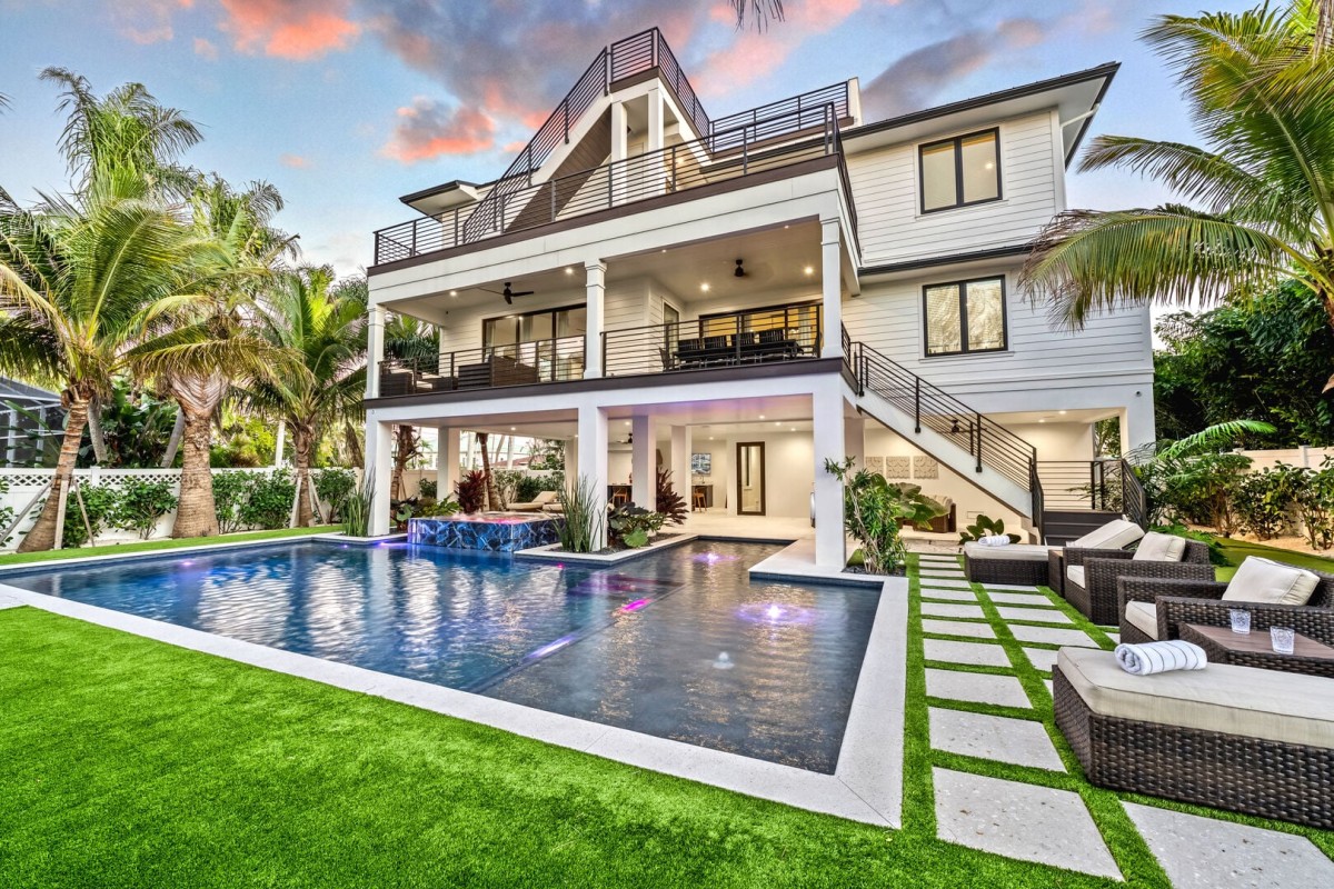 Welcome to Lido Lumiére! This modern coastal home stands out with layered balconies and sleek finishes.