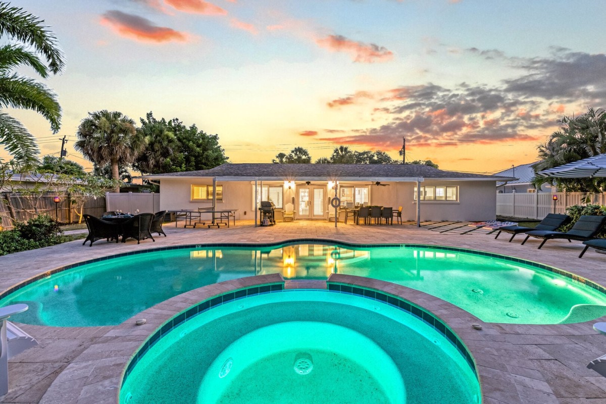 Evenings shine in Blu Sky's expansive backyard featuring a private pool, spa, grilling area, and plenty of room to gather.