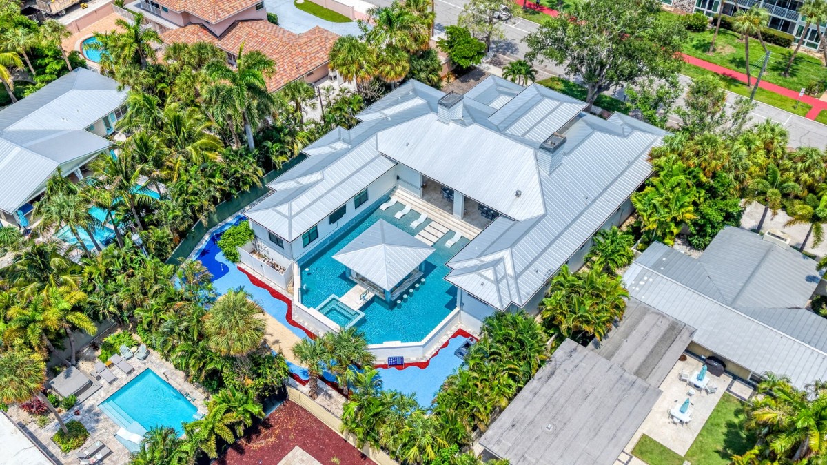 Welcome to Dream Island! A beautifully designed estate unfolds from above, showcasing its expansive layout and resort-style pool.