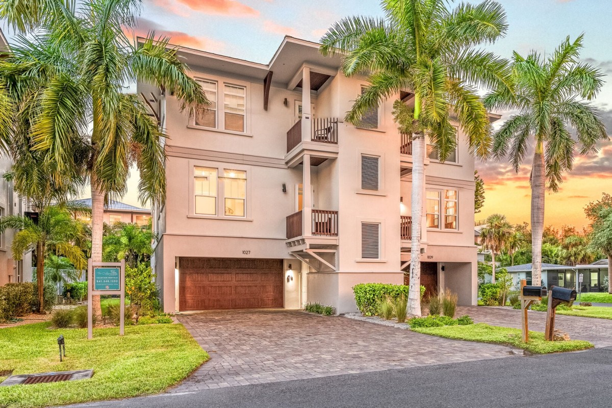 Welcome to Fiesta Playa! Your Siesta Key home base pairs tropical landscaping with multiple balconies and a two-car garage.