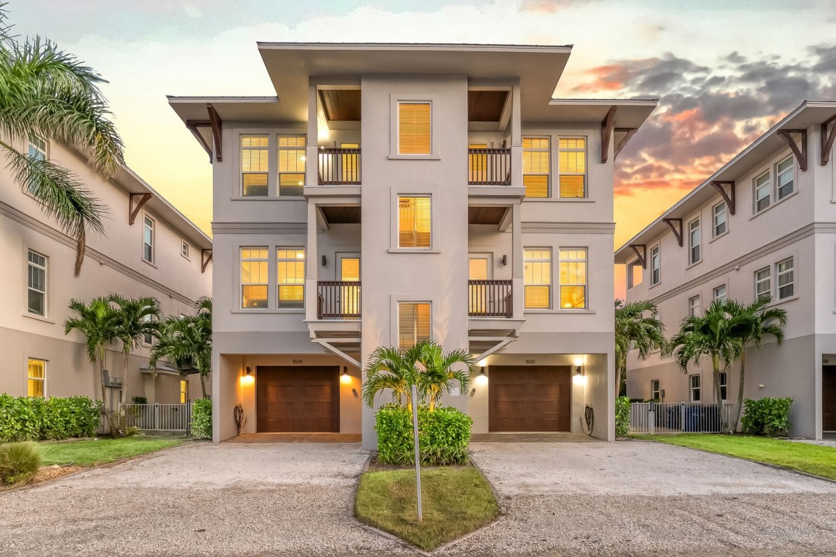 Welcome to your Siesta Key home base, with multiple balconies and tropical surroundings from top to bottom.