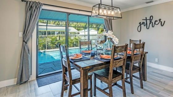 dining table in rental home with view of the pool