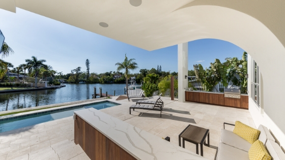 covered patio area by pool at canal-front rental property