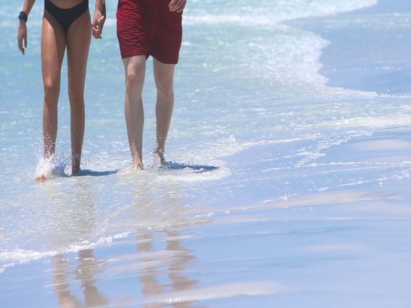 couple walking on the siesta key beach