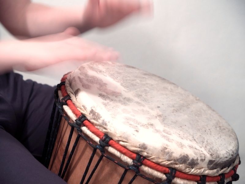 person playing drum at siesta key drum circle