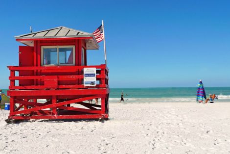 red lifeguard tower on beach