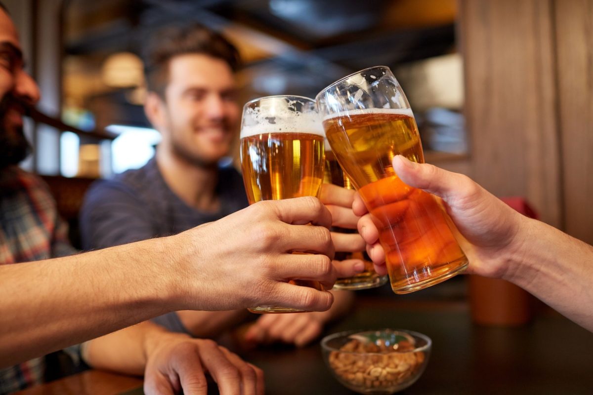 Raised beer glasses at bar!