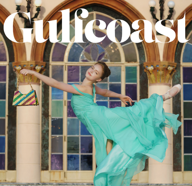 Magazine cover featuring a woman dancing in a flowing teal dress outdoors.