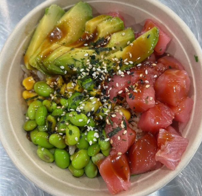 Colorful poke bowl filled with fresh tuna, avocado, edamame, and sesame seeds.