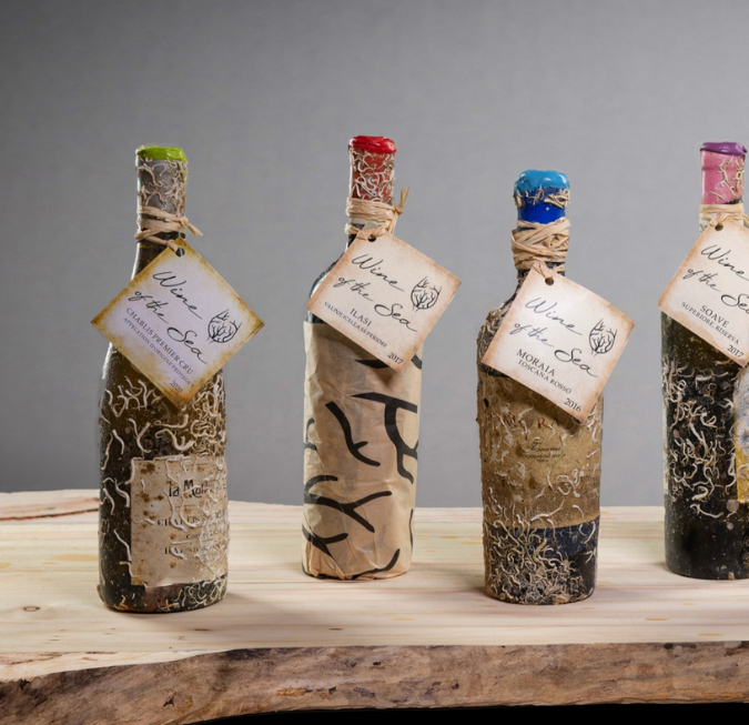 Selection of rustic wine bottles wrapped in twine with personalized gift tags.